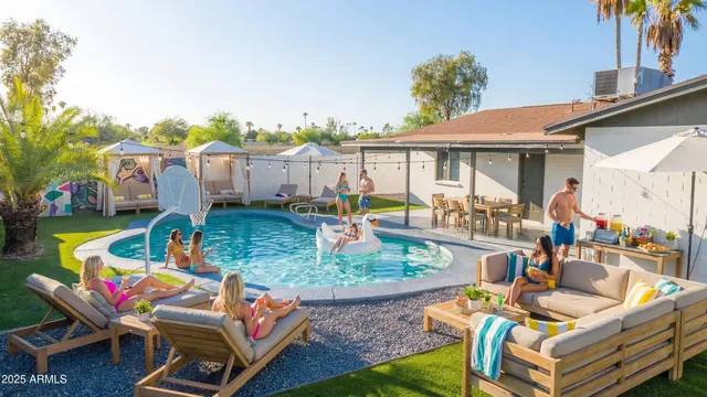 a view of a patio with couches table and chairs under an umbrella