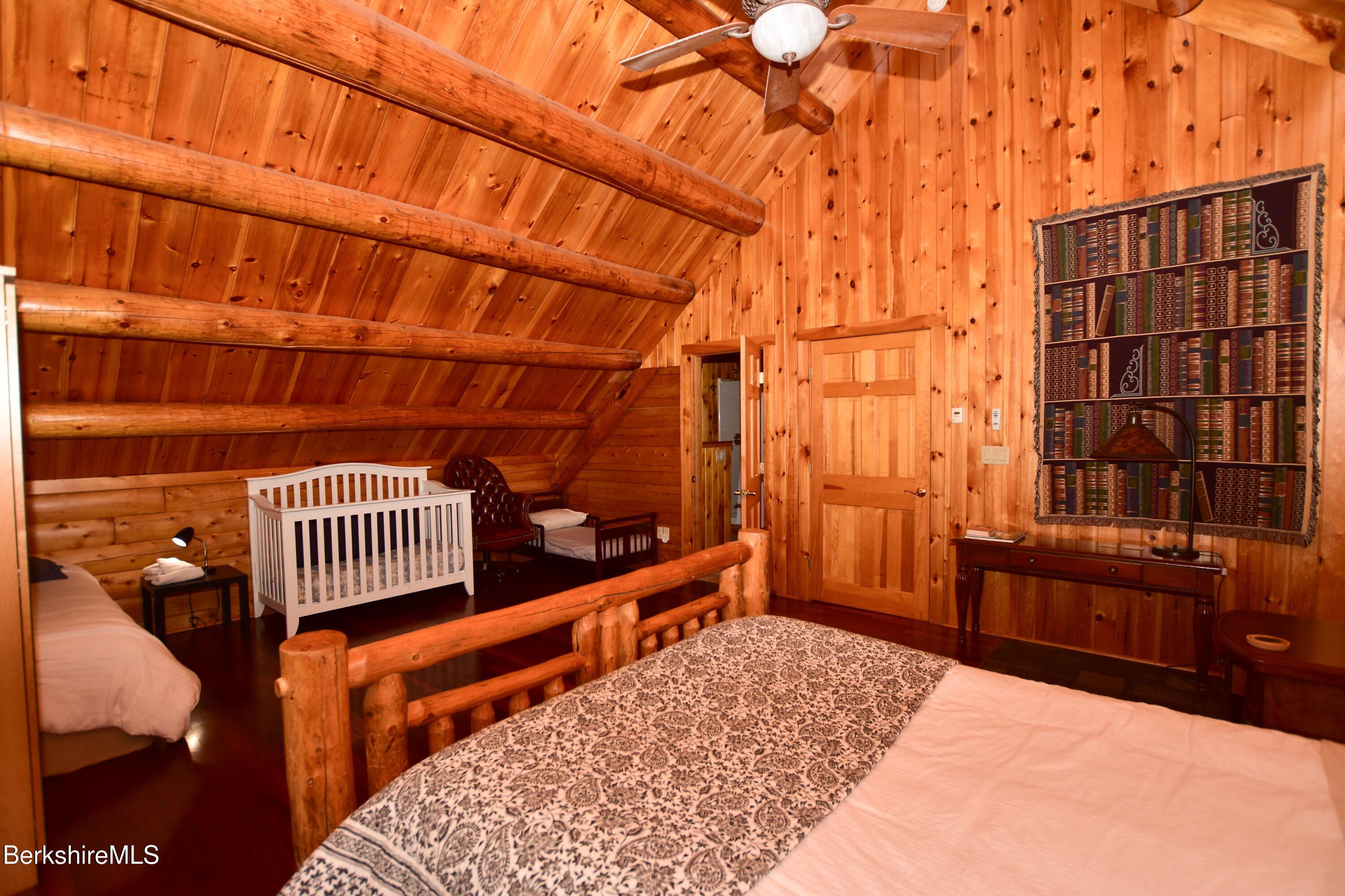 233 Algerie Road Becket, MA 01223 - Photo 29 of 48 a bedroom with a bed and wooden floor