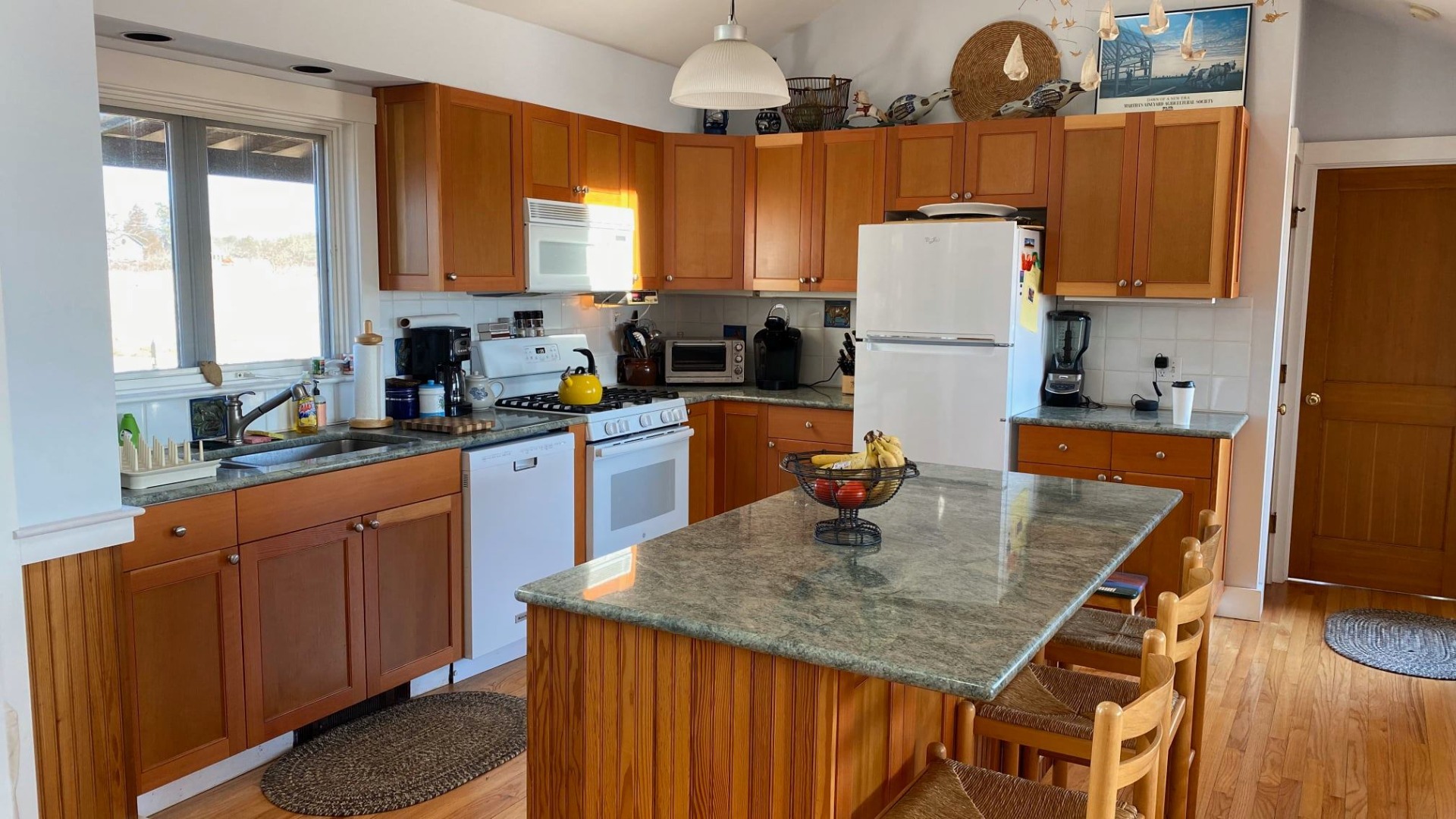 144 Pond View Farm Road West Tisbury, MA 02568 - Photo 4 of 13 a kitchen with stainless steel appliances granite countertop a sink refrigerator and microwave