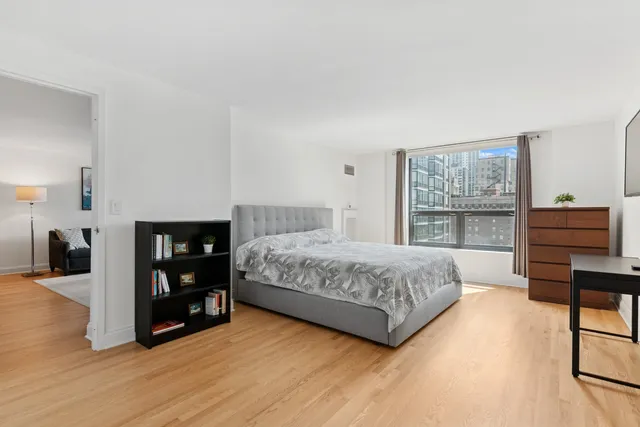 a bedroom with a bed and a table in it