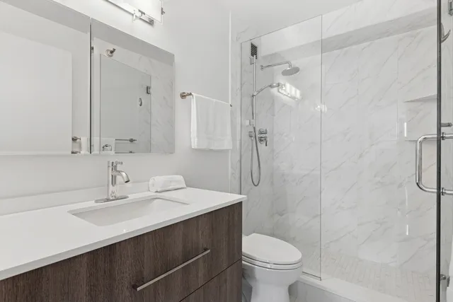 a bathroom with a sink toilet and shower