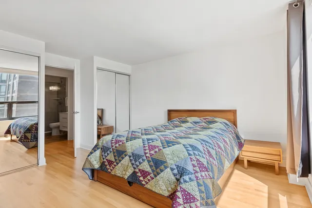 a bedroom with a bed and a view of bathroom