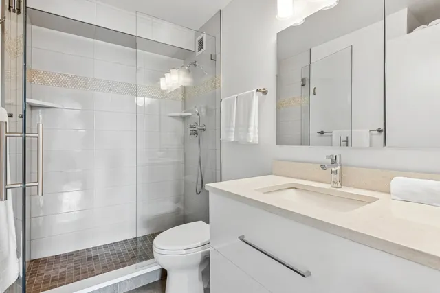 a bathroom with a sink toilet and shower