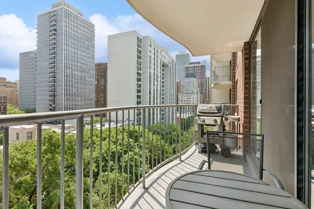 a balcony view with a large window and table
