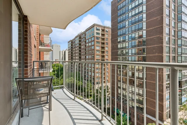 a view of a balcony with a floor to ceiling window and wooden floor