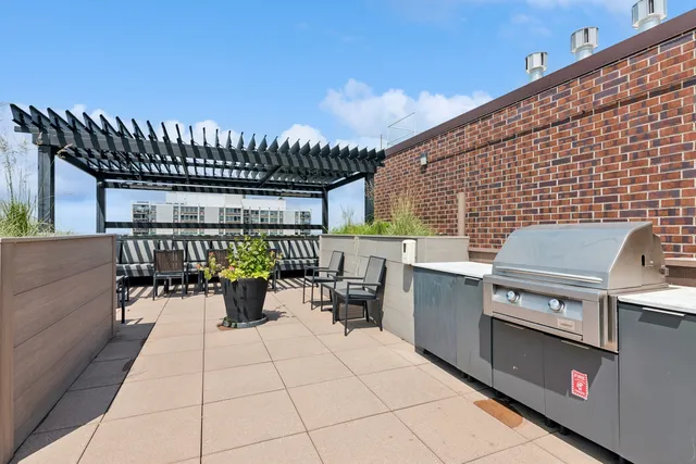 a patio with a table and chairs and potted plants