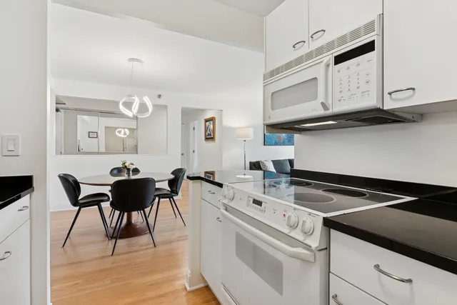 a view of kitchen with cabinets