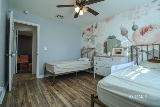 1000 West Iowa Avenue Ridgecrest, CA 93555 - Photo 22 of 32 a living room with furniture and a wooden floor