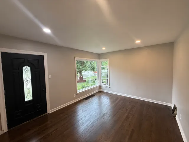 a view of room with window and wooden floor
