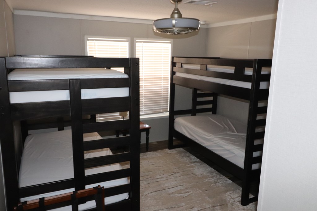 20120 Other Rocksprings, TX 78880 - Photo 15 of 22 a bedroom with a bed and a chandelier