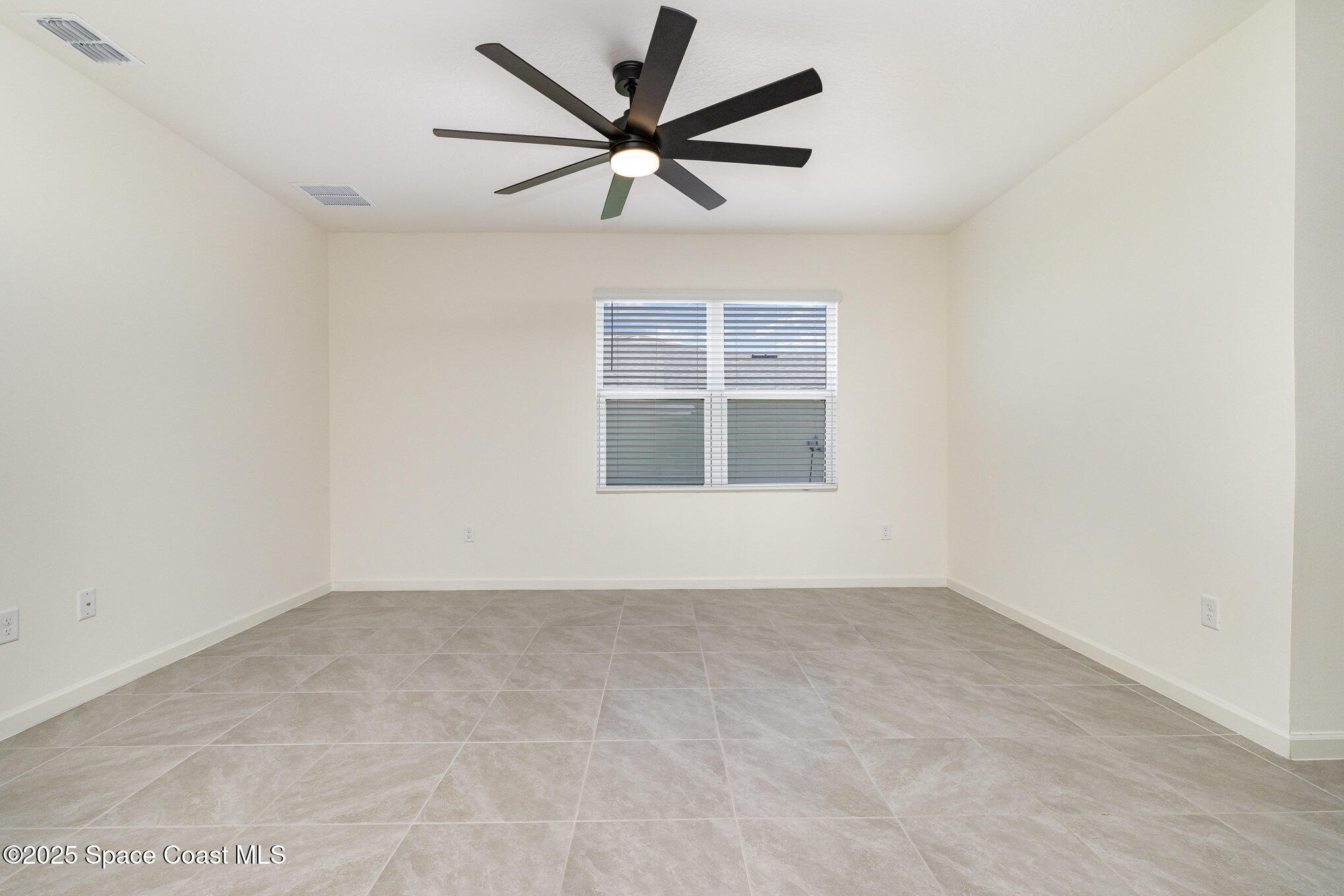6714 Topaz Drive Grant-Valkaria, FL 32949 - Photo 12 of 33 an empty room with a window and a ceiling fan