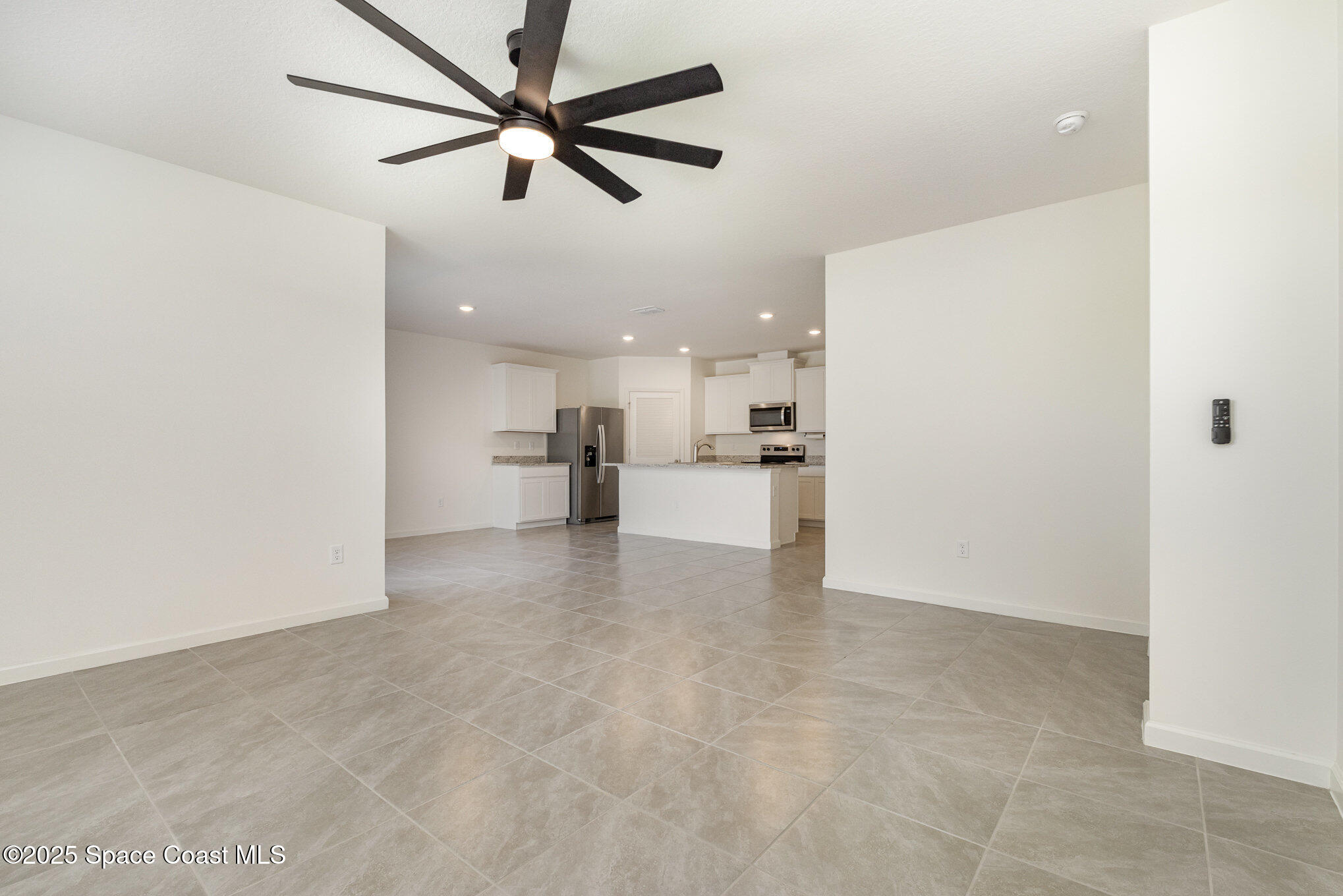 6714 Topaz Drive Grant-Valkaria, FL 32949 - Photo 15 of 33 a view of a kitchen with a sink and a refrigerator