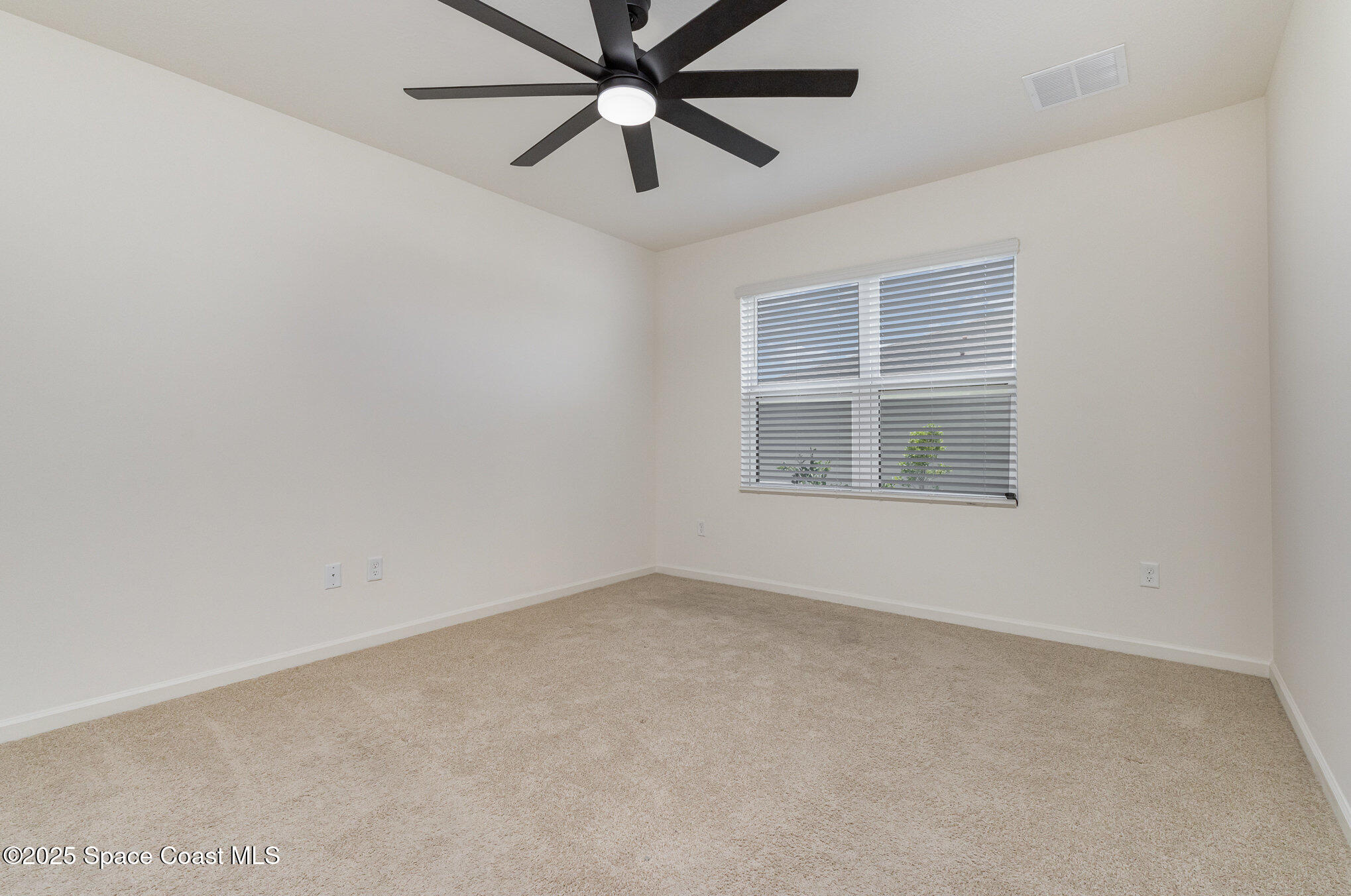 6714 Topaz Drive Grant-Valkaria, FL 32949 - Photo 16 of 33 an empty room with a window and a fan
