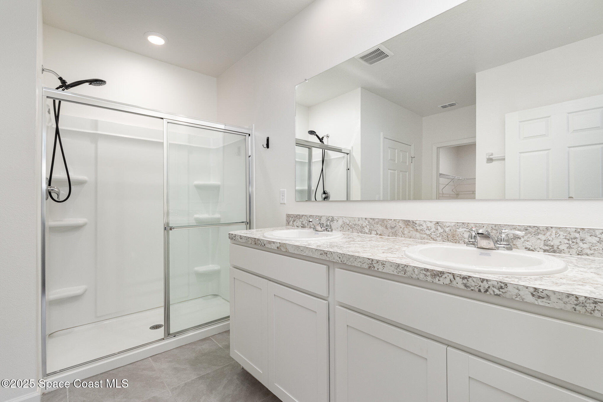 6714 Topaz Drive Grant-Valkaria, FL 32949 - Photo 18 of 33 a bathroom with a granite countertop sink mirror and shower