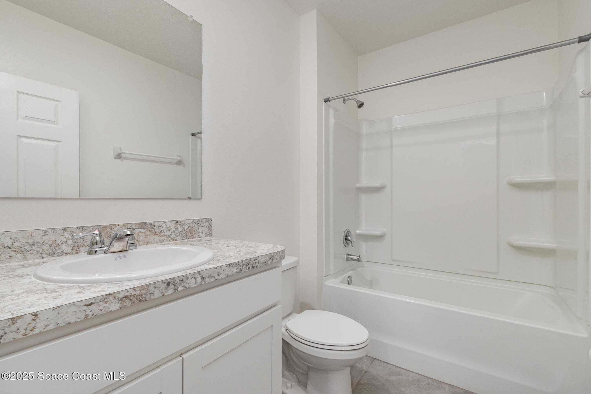 6714 Topaz Drive Grant-Valkaria, FL 32949 - Photo 22 of 33 a bathroom with a granite countertop sink toilet mirror and shower