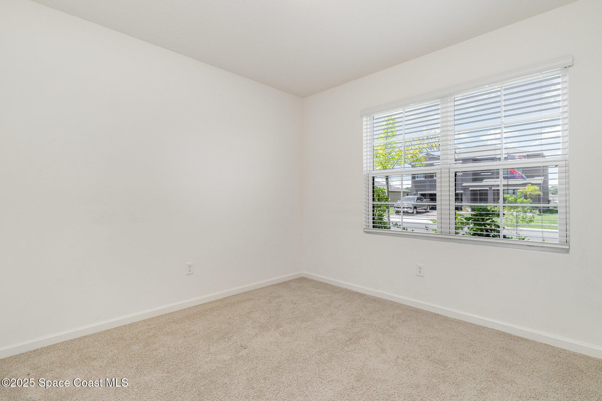 6714 Topaz Drive Grant-Valkaria, FL 32949 - Photo 23 of 33 an empty room with windows