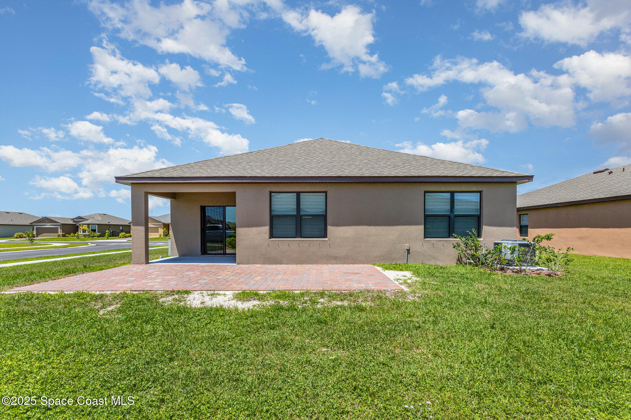 6714 Topaz Drive Grant-Valkaria, FL 32949 - Photo 26 of 33 a front view of a house with garden and porch