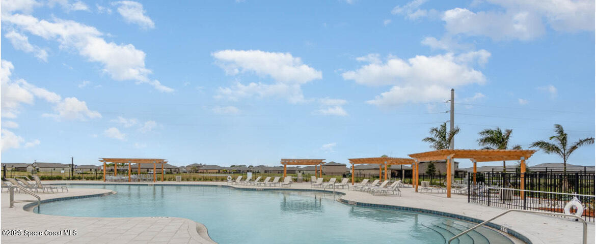 6714 Topaz Drive Grant-Valkaria, FL 32949 - Photo 29 of 33 a view of a lake with a table and chairs
