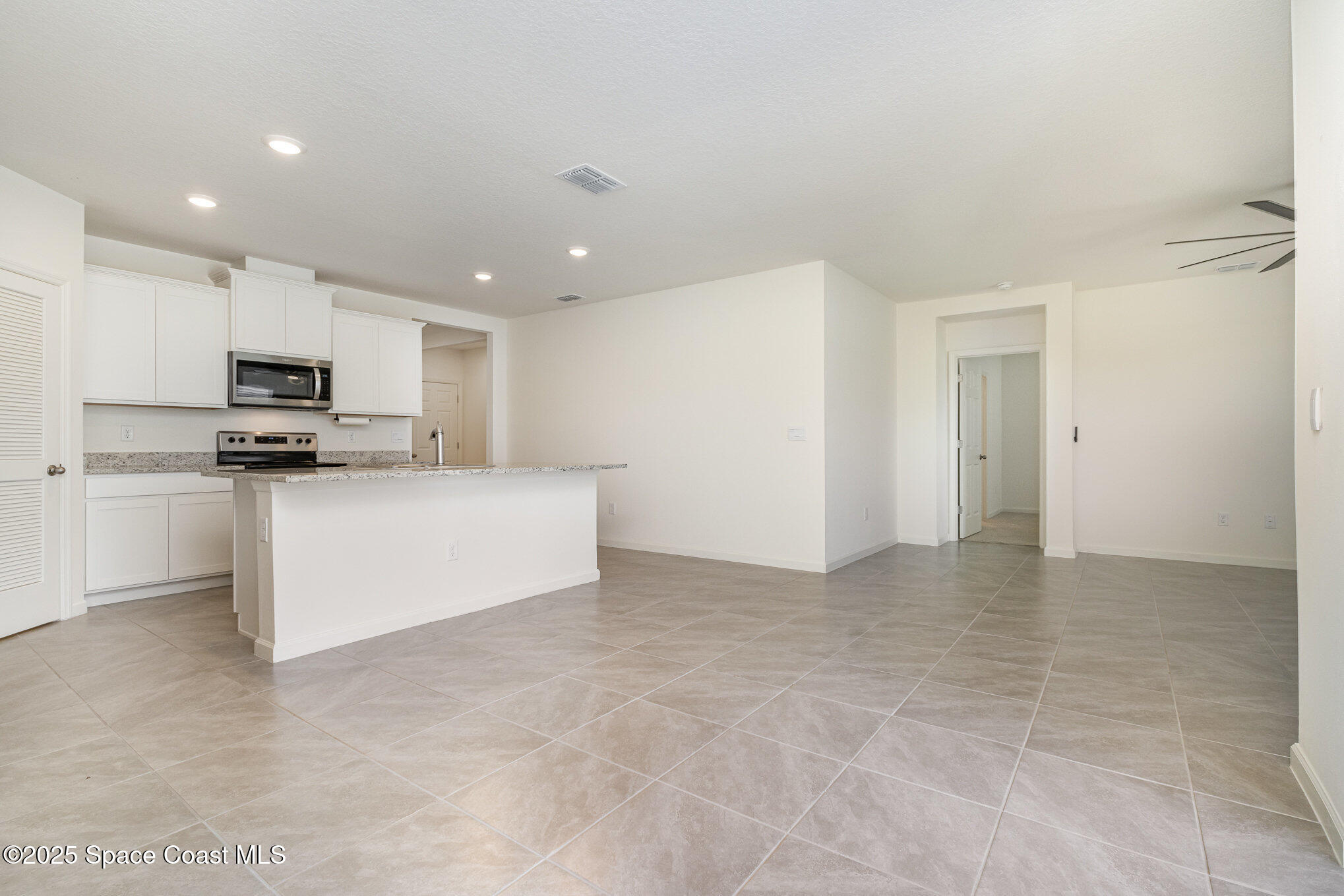 6714 Topaz Drive Grant-Valkaria, FL 32949 - Photo 6 of 33 a view of kitchen with microwave and cabinets