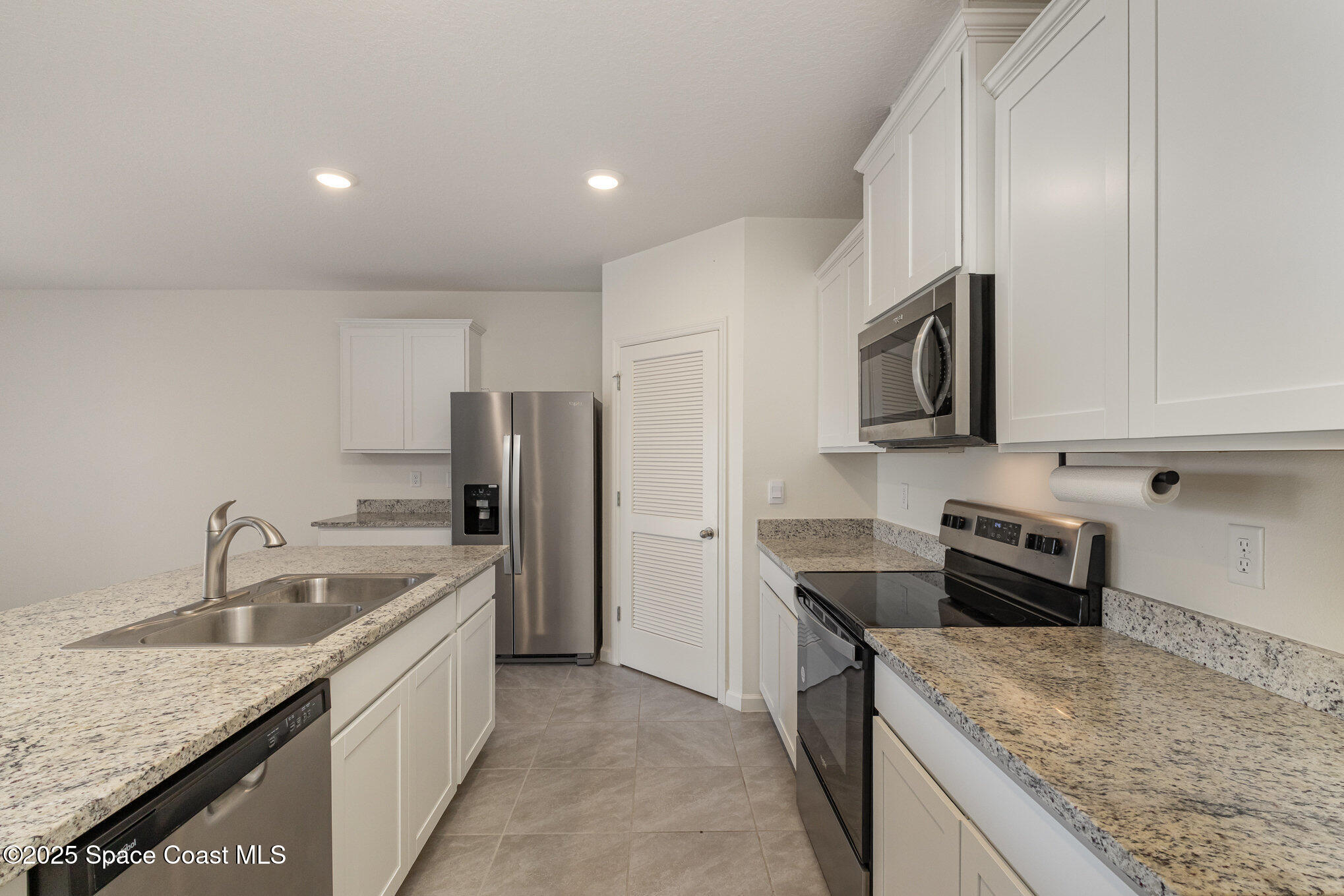 6714 Topaz Drive Grant-Valkaria, FL 32949 - Photo 9 of 33 a kitchen with stainless steel appliances granite countertop a sink stove and refrigerator