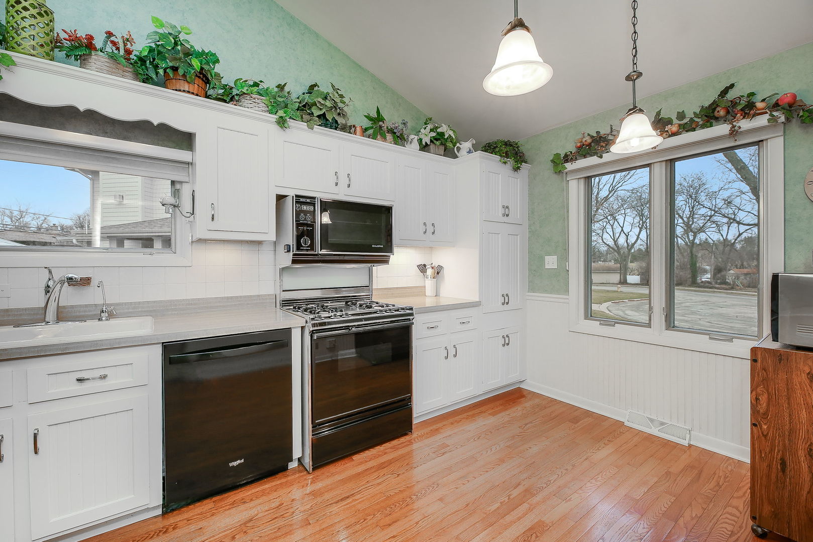 5924 Carpenter Street Downers Grove, IL 60516 - Photo 8 of 28 a kitchen with granite countertop a stove a sink and wooden floor