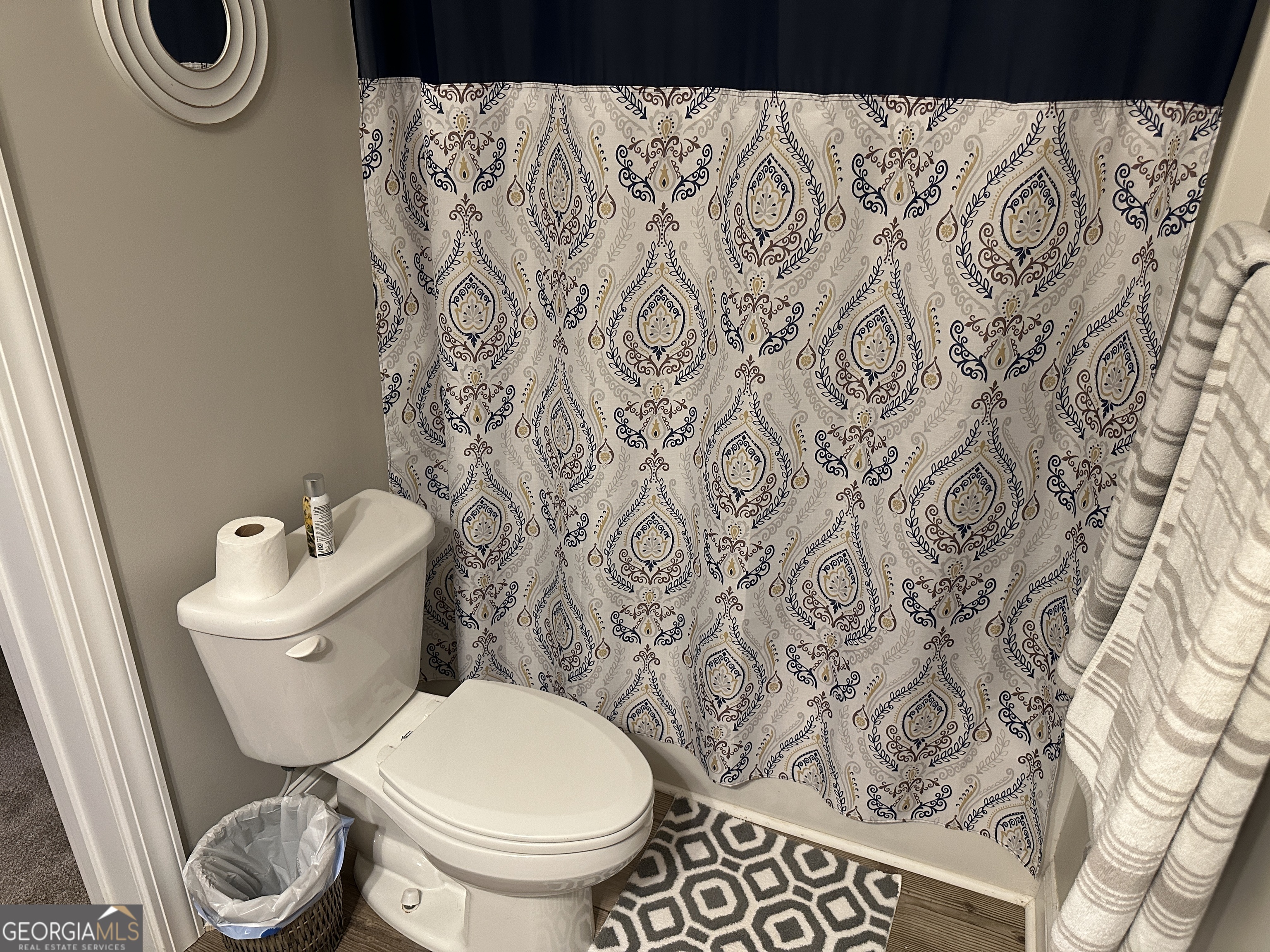 88 Old Vineyard Way Cleveland, GA 30528 - Photo 6 of 8 a white toilet sitting next to a shower curtain