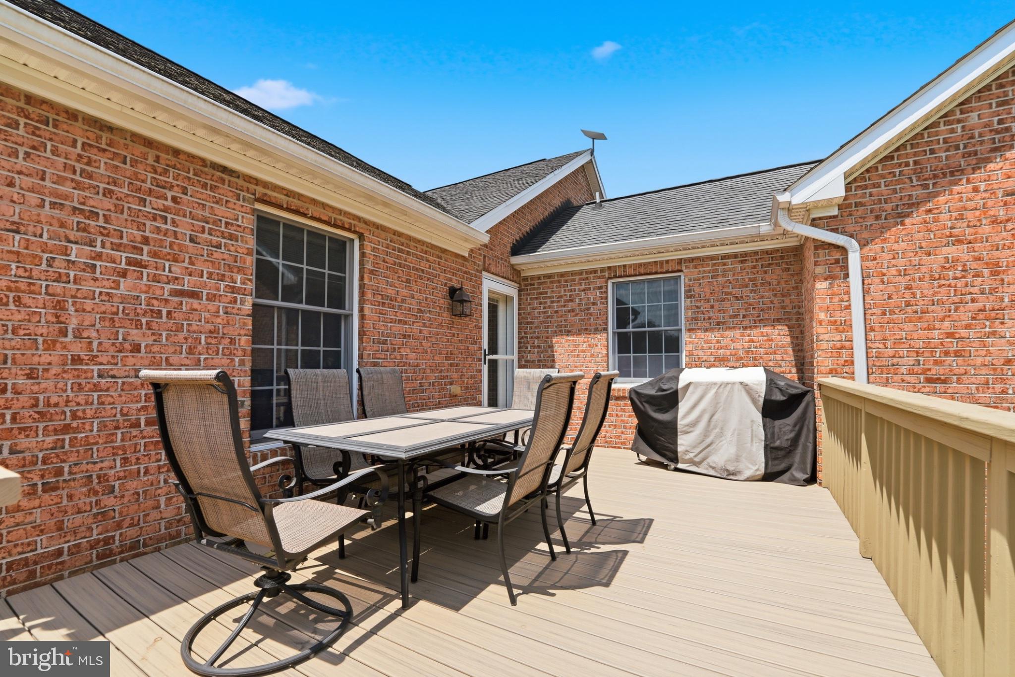11337 Old Stillhouse Road Boston, VA 22713 - Photo 33 of 58 a view of a roof deck with table and chairs and wooden floor