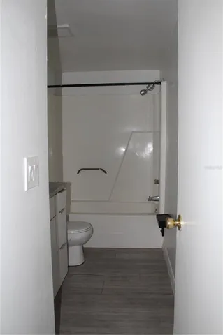 a bathroom with a shower a toilet and a sink