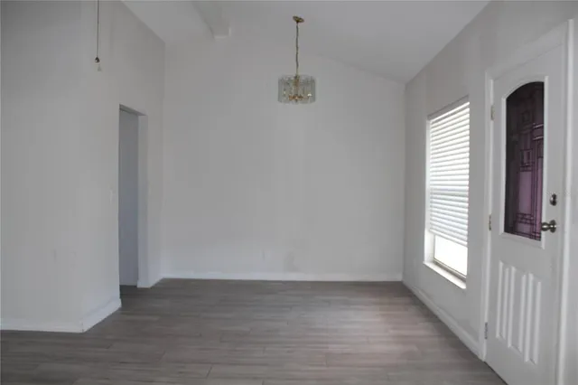 a view of a room with wooden floor and windows