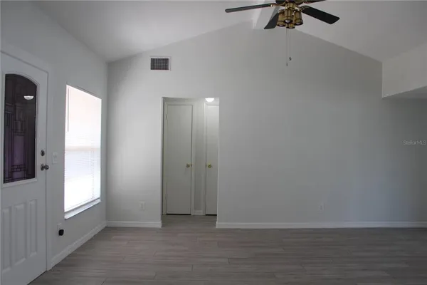 wooden floor in an empty room with a window