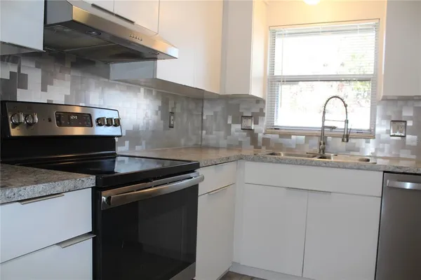 a kitchen with a stove and a sink