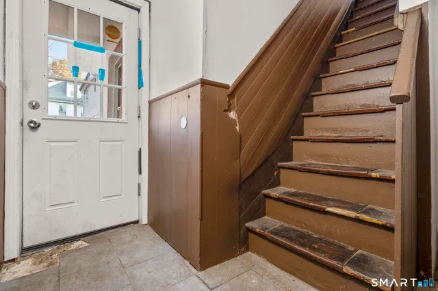 a view of staircase with lots of frames on wall
