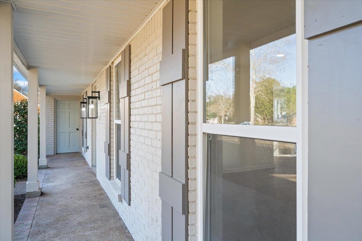 1676 Miller Farms Road Germantown, TN 38138 - Photo 3 of 37 Covered front porch featuring white brick siding and gray decorative shutters
