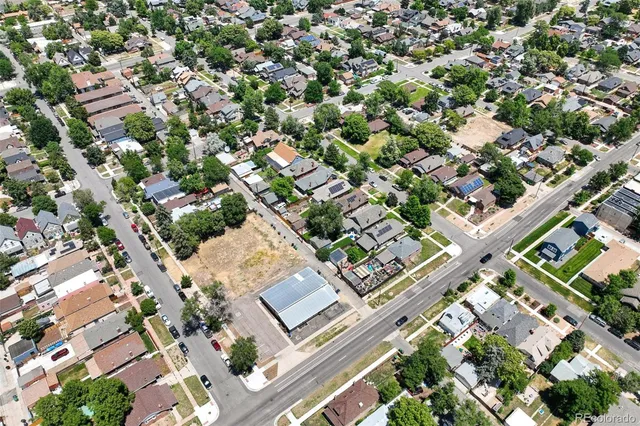an aerial view of a residential houses with yard