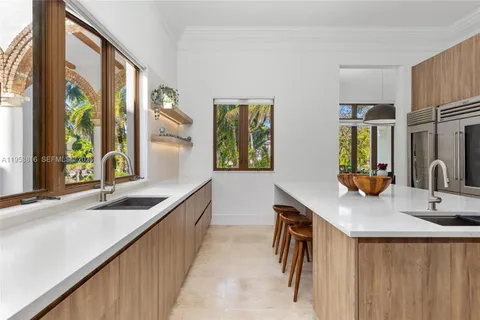 a kitchen with sink and a mirror