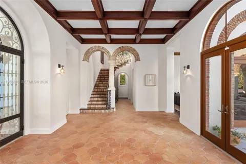 a spacious bedroom with a bed and glass door