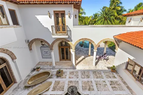 a view of a lake with boats and palm trees