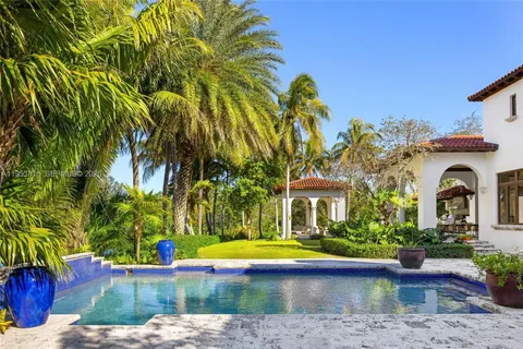 a view of a house with swimming pool and a yard