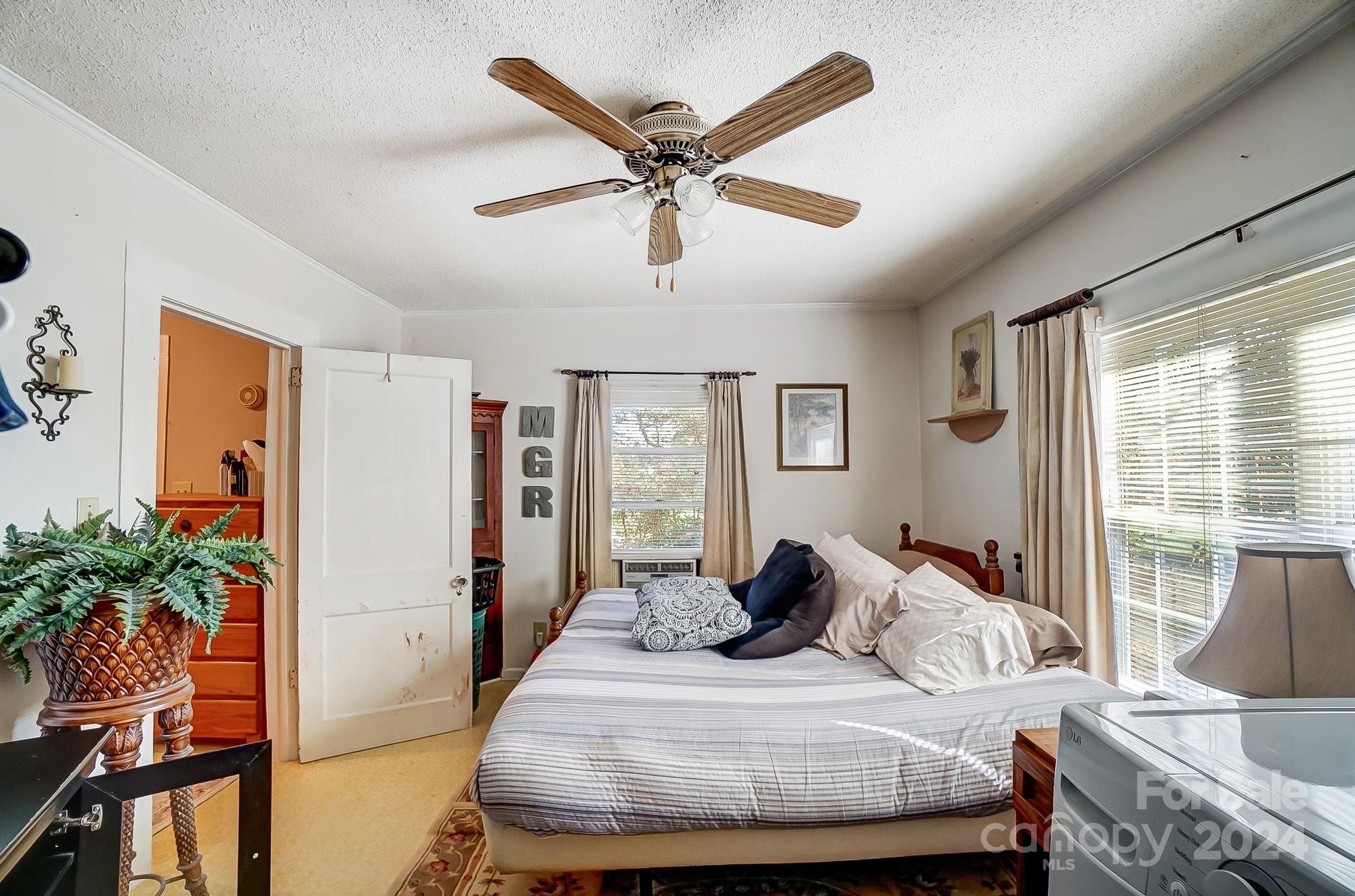 2020 Clontz Long Road Monroe, NC 28110 - Photo 19 of 30 a bedroom with a large bed and a chandelier