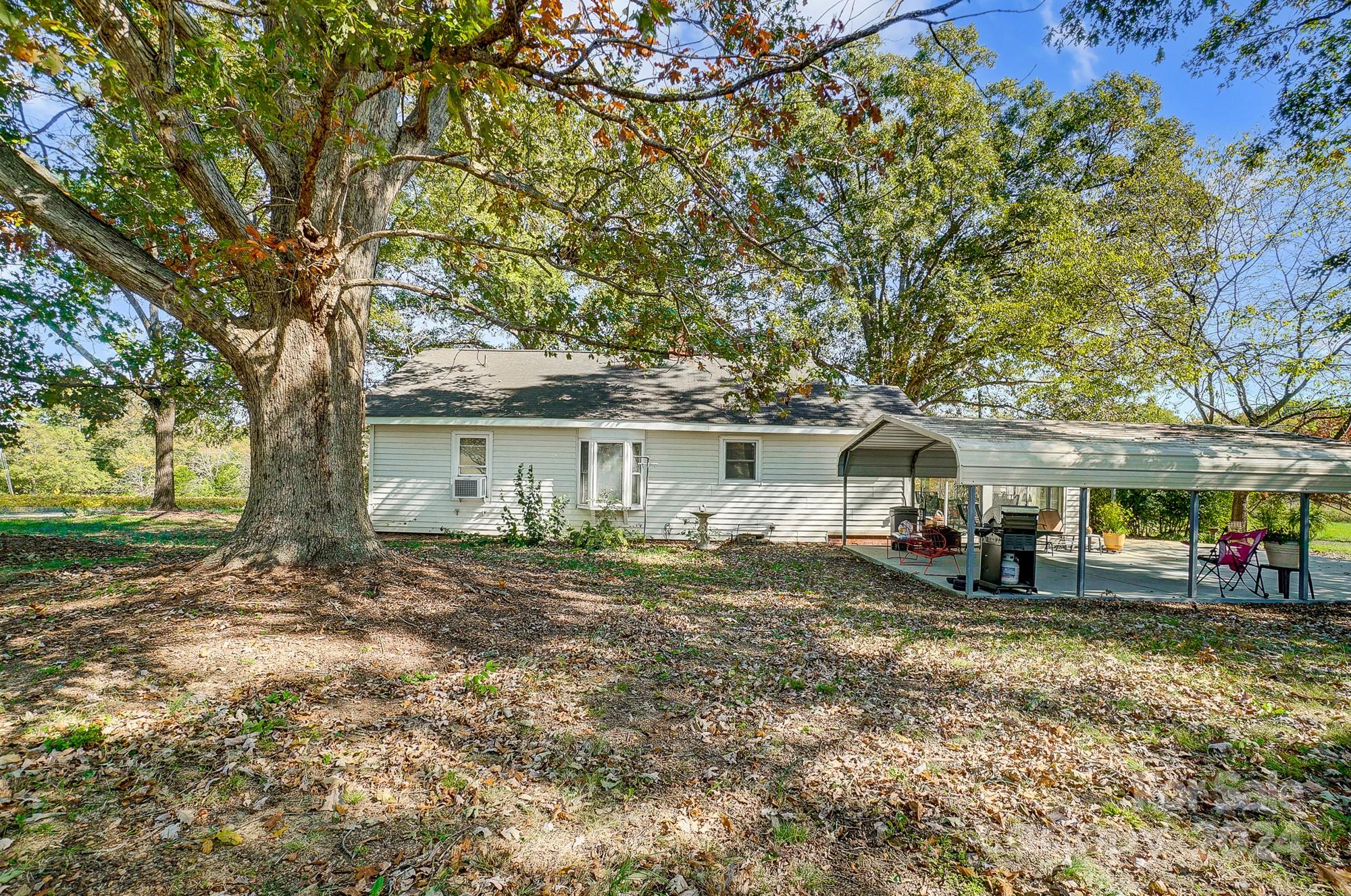 2020 Clontz Long Road Monroe, NC 28110 - Photo 27 of 30 a view of a house with a large tree and a big yard