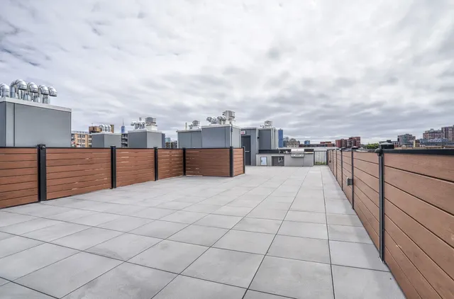 a terrace with outdoor seating and city view
