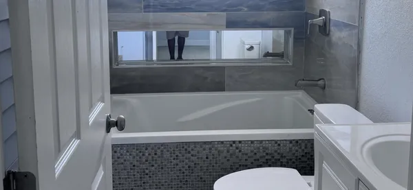 a bathroom with a toilet and a bathtub