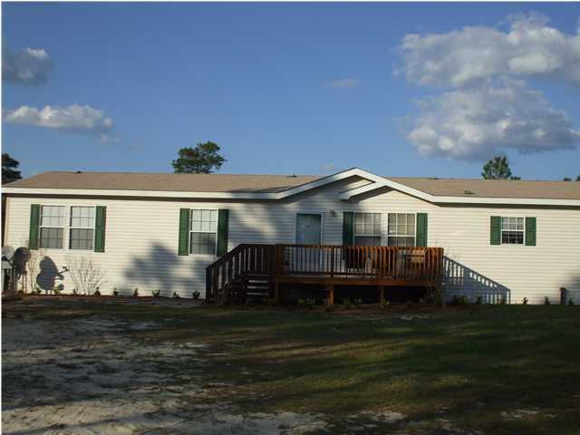 477 Don Graff Road Freeport, FL 32439 - Photo 1 of 15 a front view of a house with garden