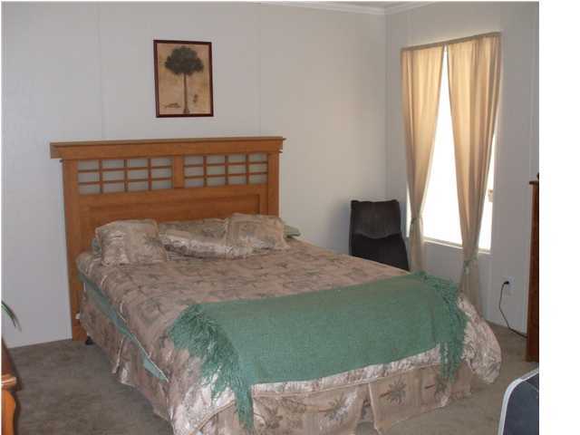 477 Don Graff Road Freeport, FL 32439 - Photo 11 of 15 a bedroom with a bed and a window