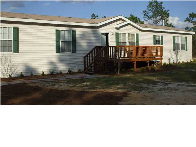 477 Don Graff Road Freeport, FL 32439 - Photo 2 of 15 a front view of a house with a yard