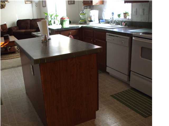 477 Don Graff Road Freeport, FL 32439 - Photo 7 of 15 a kitchen with a sink and cabinets