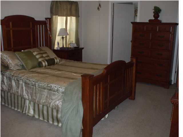 477 Don Graff Road Freeport, FL 32439 - Photo 9 of 15 a bed sitting in a bedroom next to a window