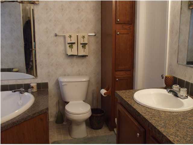 477 Don Graff Road Freeport, FL 32439 - Photo 10 of 15 a bathroom with a granite countertop toilet sink and mirror