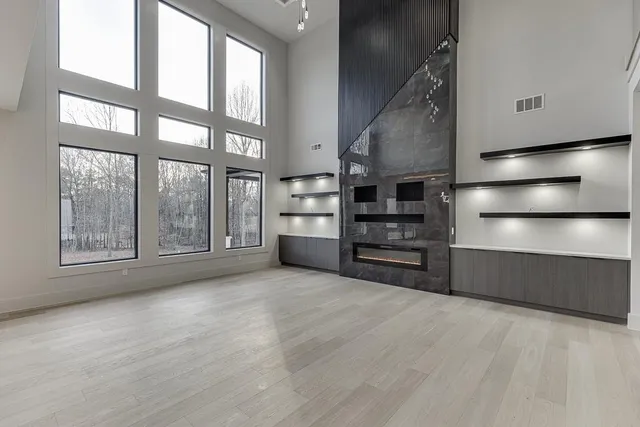 a large kitchen with a large counter top sink and stainless steel appliances