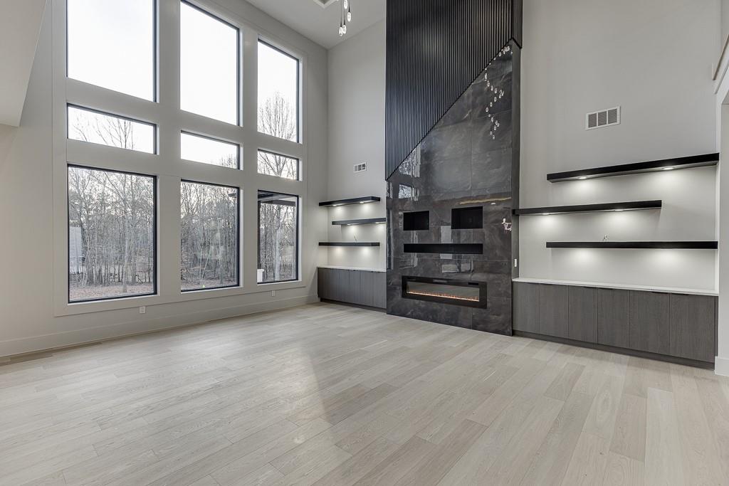 4238 Hamilton Mill Road Buford, GA 30519 - Photo 12 of 100 a view of an empty room with a fireplace and windows